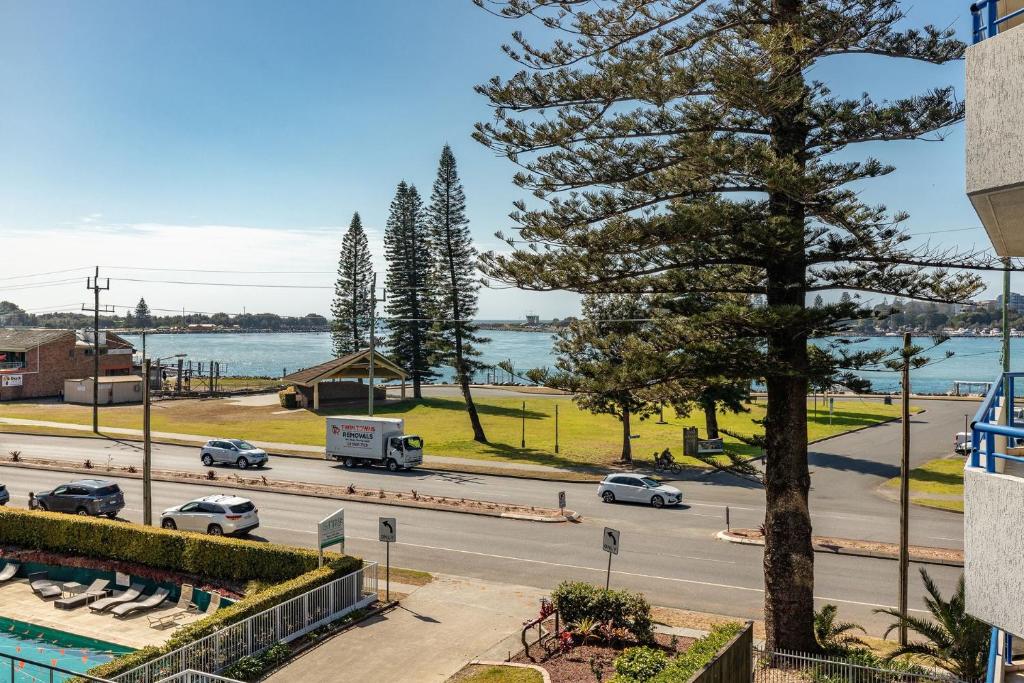 a view of a street with a tree and a road at Heritage 303 in Tuncurry