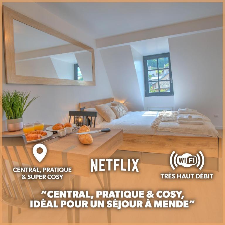 - une chambre avec un lit et une table avec un miroir dans l'établissement Le Rustique - Netflix/Wi-fi Fibre - Séjour Lozère, à Mende