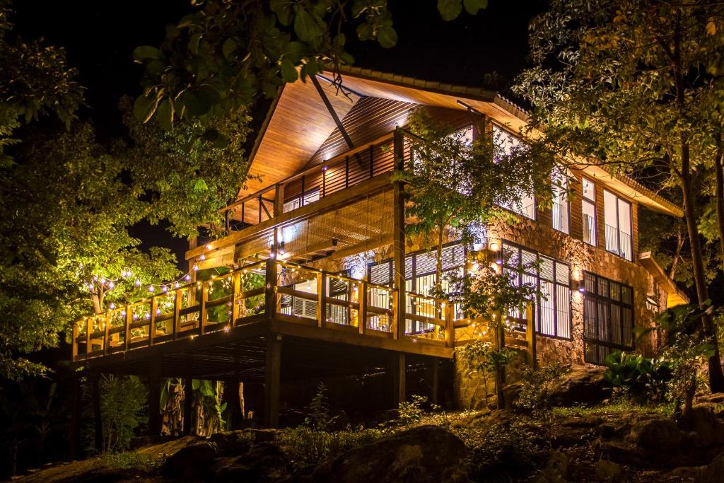 a house in the woods at night at Payana Kampot in Kampot