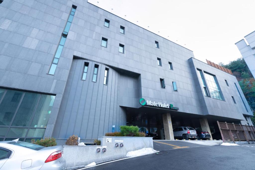 a building with a car parked in front of it at Mate Hotel Paju in Paju