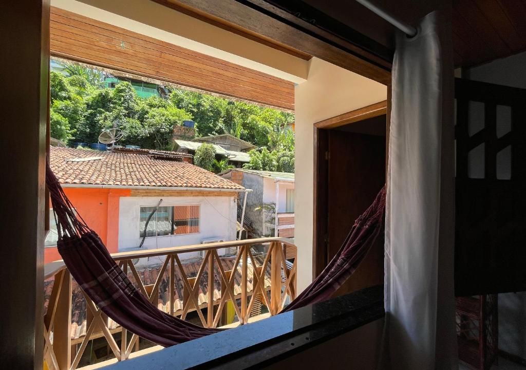 a room with a balcony with a hammock at Pousada Estevao in Morro de São Paulo