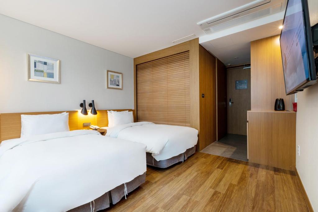 Postel nebo postele na pokoji v ubytování Mate Hotel Paju