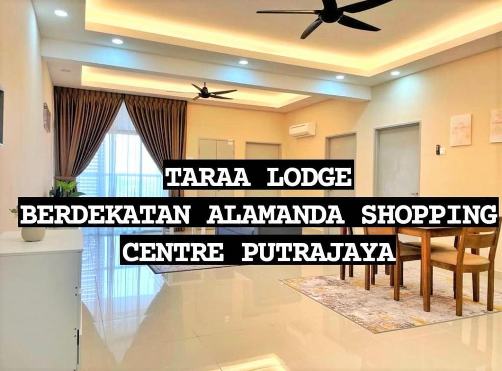 a living room with a ceiling fan and a table at Taraa Lodge PutrajayaMuslim in Putrajaya