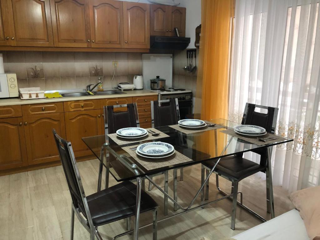 a kitchen with a dining room table and chairs at STOUDIO VOUL in Alexandroupoli