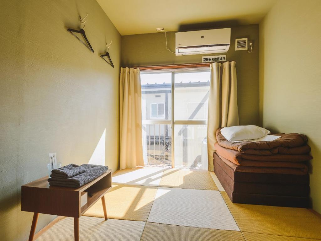 Postel nebo postele na pokoji v ubytování guesthouse SHIBAFU
