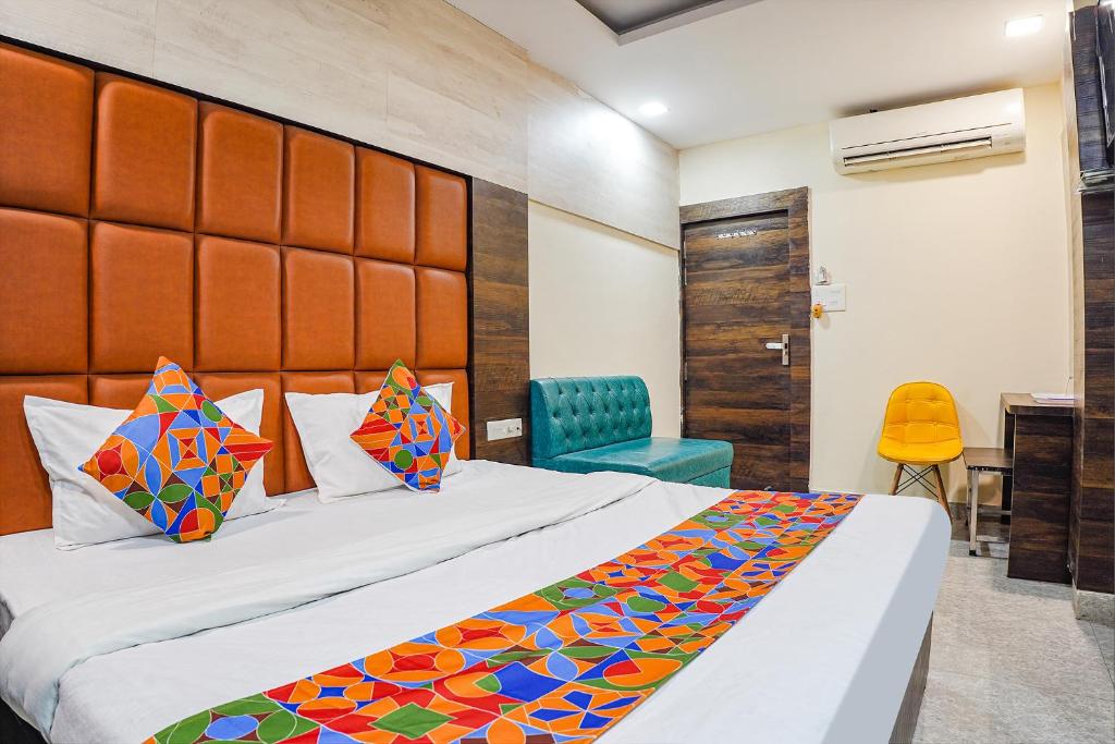 a hotel room with a bed and a chair at FabHotel Brij Residency in Naiāpura