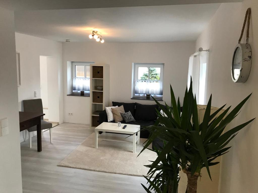 a living room with a couch and a table at Wohnung mit eigenem Zugang in Hochdorf