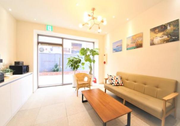 a living room with a couch and a table at Hotel MARE in Busan