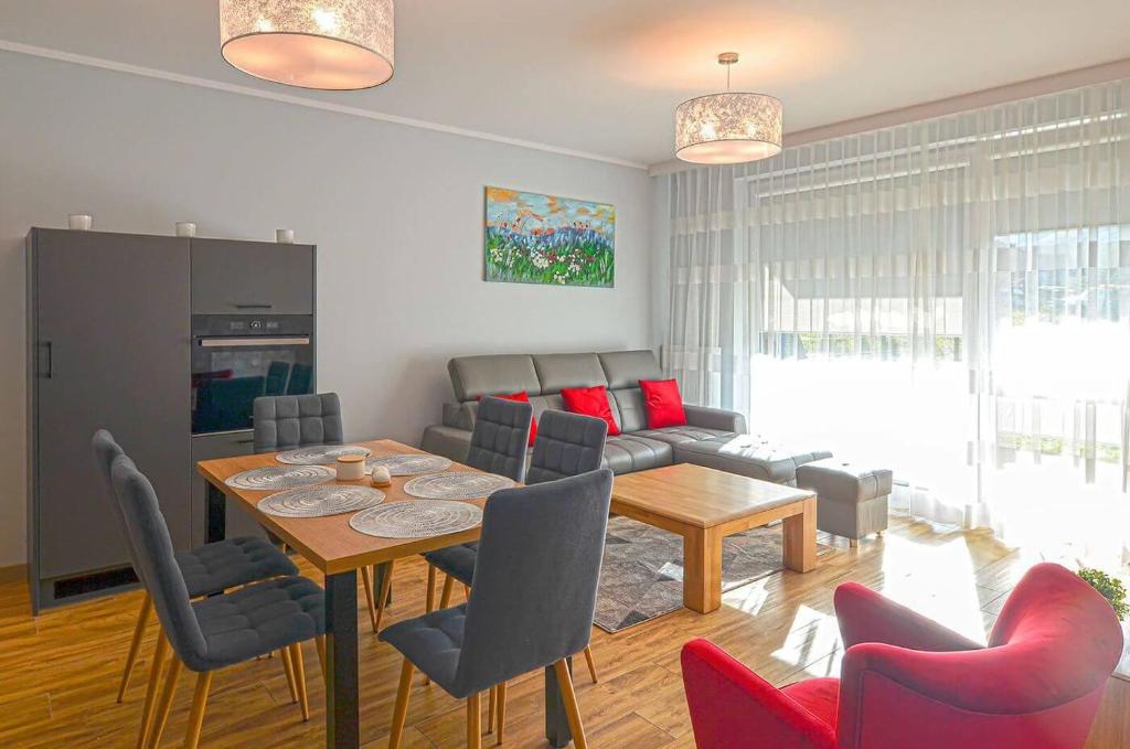 a living room with a table and a couch at Beskid Apartment in Szczyrk