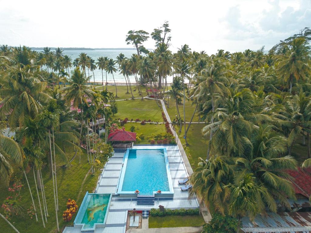 an aerial view of a resort with a pool and palm trees at Silver Sand Sea Princess Beach Resort in Manglutān