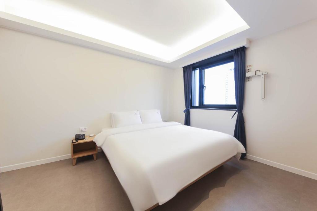 Postel nebo postele na pokoji v ubytování Bonatree Hotel