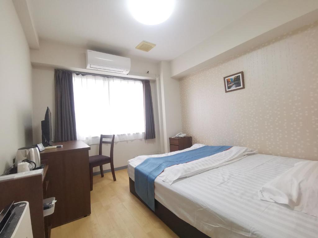 Postel nebo postele na pokoji v ubytování Business Hotel Azuma