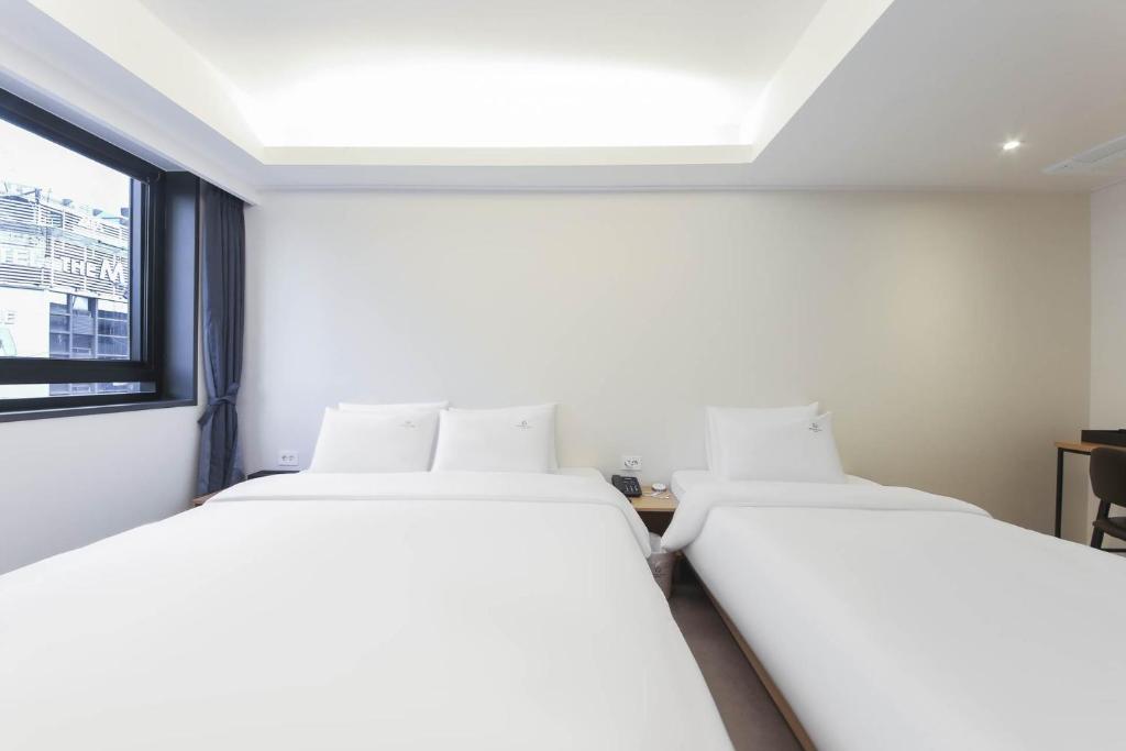 Postel nebo postele na pokoji v ubytování Bonatree Hotel