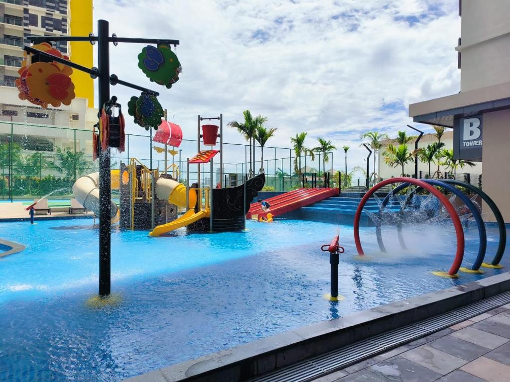a pool with a water park with slides and rides at Wanz Barakah Homestay @ Bali residence in Melaka