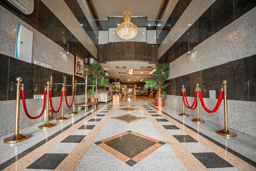 a lobby with red ribbon barriers in a building at فندق غالية احد in Al Madinah