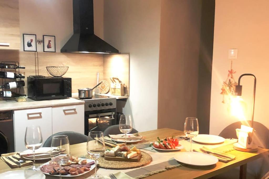 a table with plates of food and wine glasses at Specious Modern Apartment in Sofia