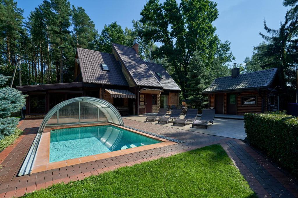 a house with a swimming pool in the yard at Luxury villas Kaunas in Šlienava