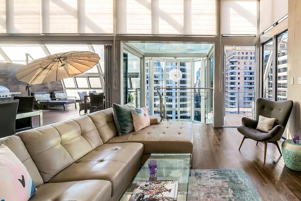 a living room with a couch and a table at Luxury Loft in the CBD with Outdoor Living in Sydney