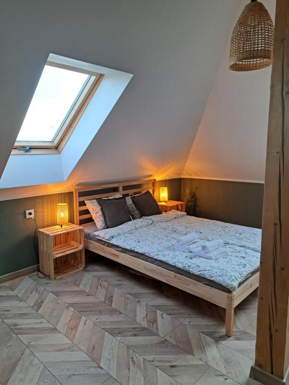 a bedroom with a large bed in a attic at Zacisze Arturówka in Laskowa