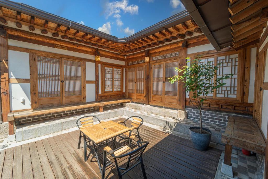 a patio with a table and chairs on a wooden deck at private house JNP stay in Seoul