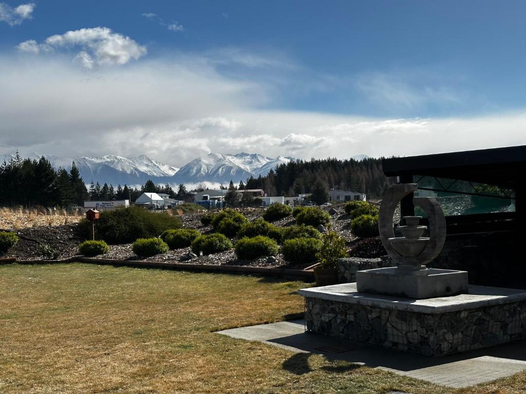 a statue in a park with mountains in the background at LH Twizel Fountain Retreat in Twizel