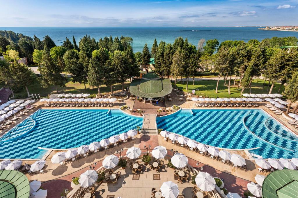an aerial view of a pool at a resort with umbrellas at SOL by Meliá Nessebar Palace All Inclusive in Nesebar