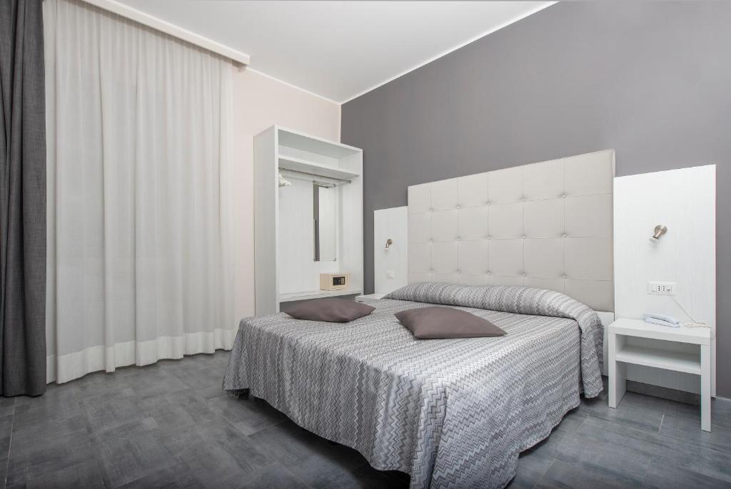 Postel nebo postele na pokoji v ubytování Hotel Assarotti