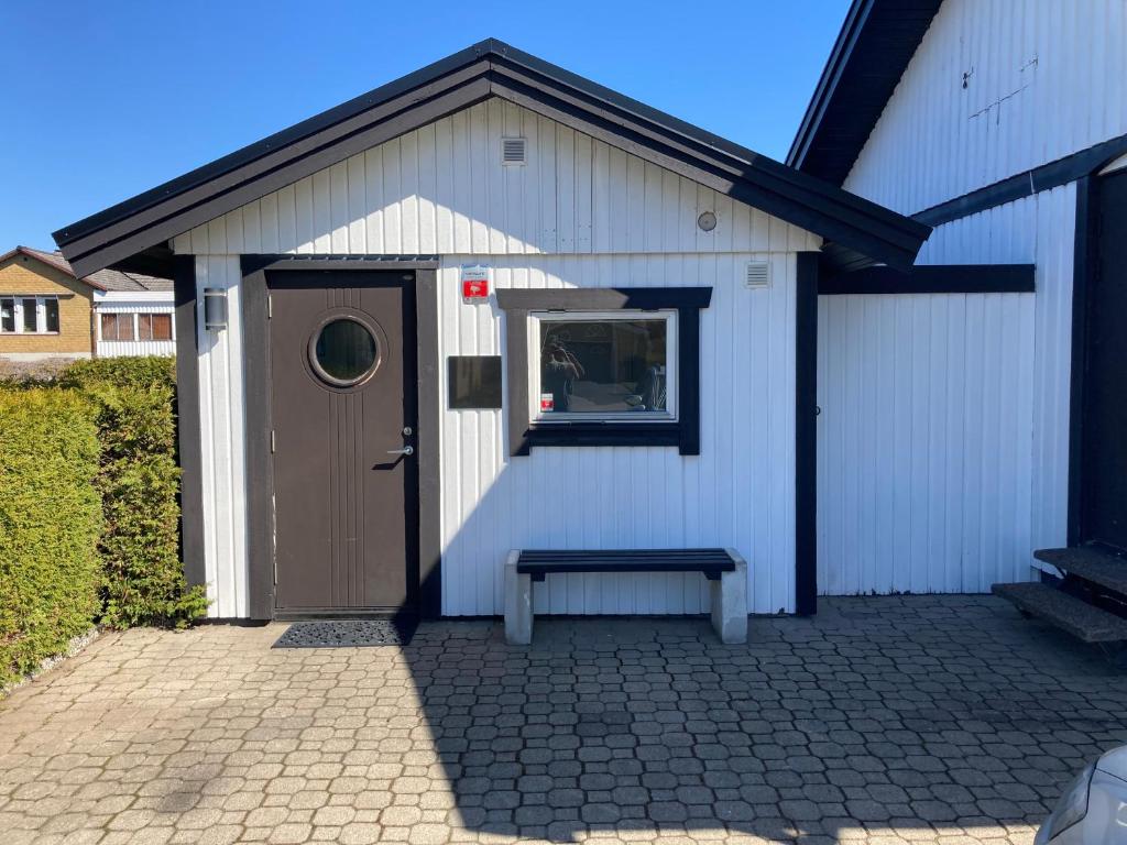 a white building with a bench in front of it at Annexet in Hässleholm