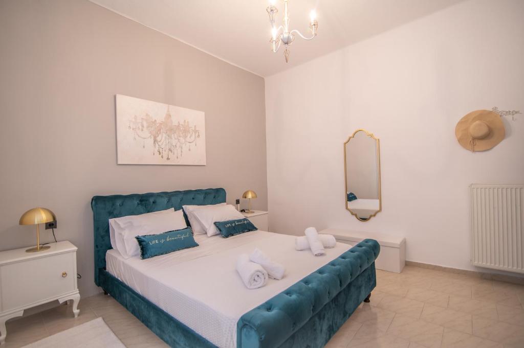 a bedroom with a large bed with towels on it at DION'S HOME with Private Parking at the Center of Kos Town in Kos