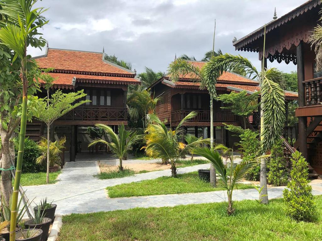 a resort with a pathway leading to a building at Apsara Khmer House in Siem Reap