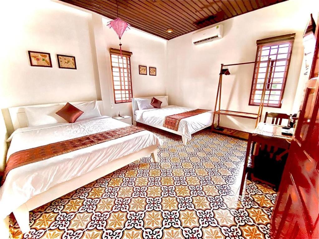 Postel nebo postele na pokoji v ubytování SEVEN HOMESTAY(HUE)