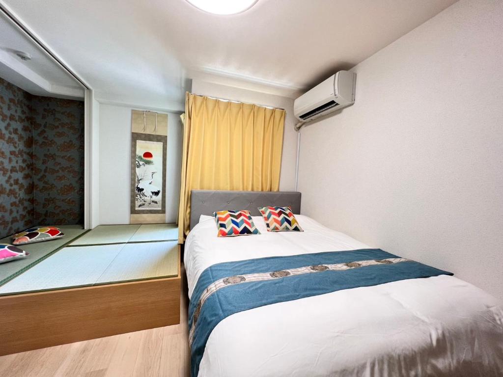 Postel nebo postele na pokoji v ubytování 大阪旅・四葉　