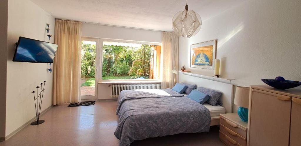 a bedroom with a bed and a window at Wohlfühl & Wellness Oase in Neustadt an der Weinstraße