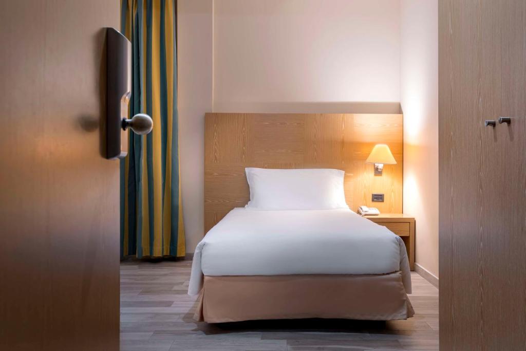 Postel nebo postele na pokoji v ubytování Best Western Cavalieri Della Corona