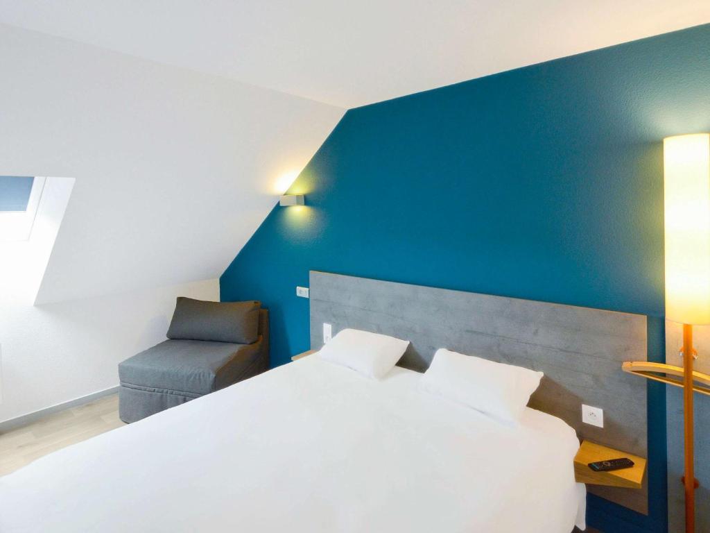Postel nebo postele na pokoji v ubytování ibis budget Vannes