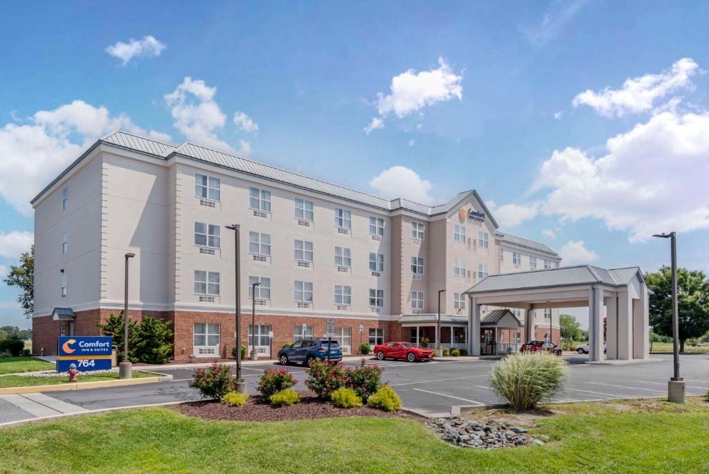 a large white building with a parking lot at Comfort Inn & Suites in Dover