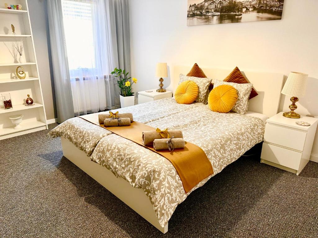 a bedroom with a large bed with yellow pillows at Grey House in Wrocław