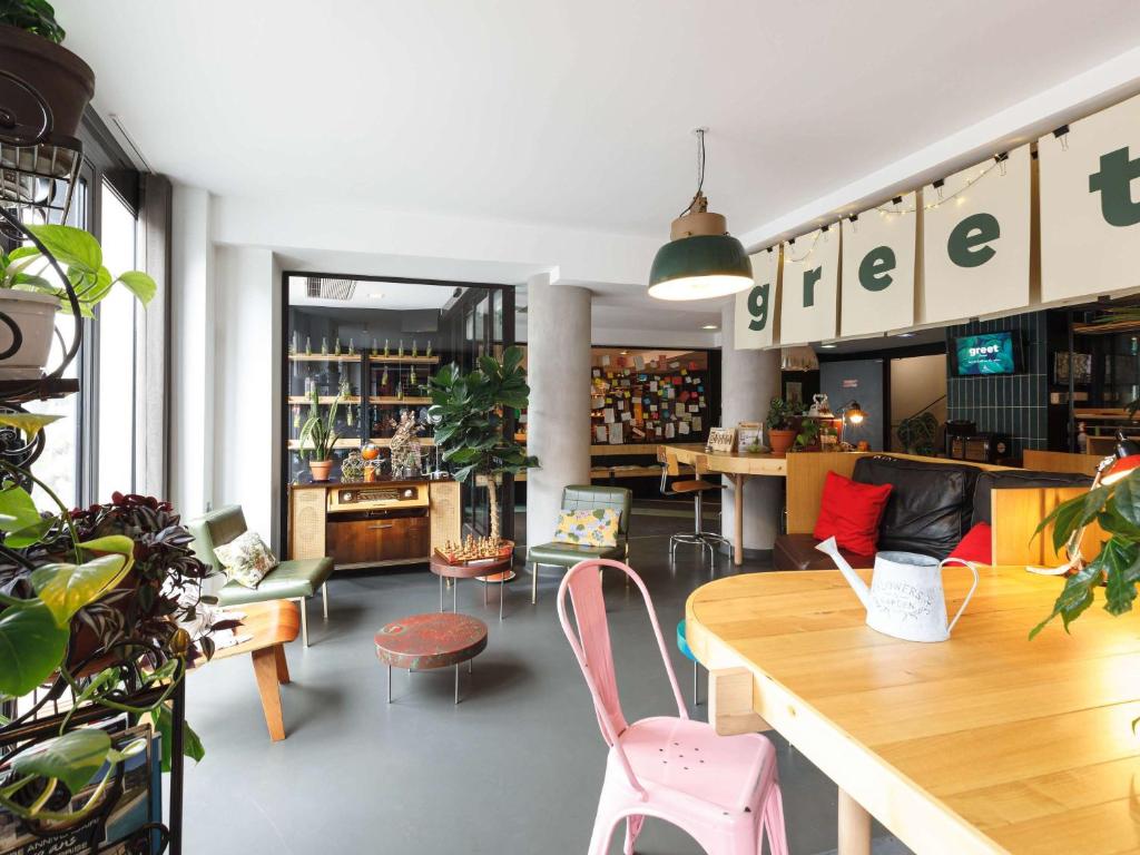 a store with a table and chairs in a room at Greet Hotel Lyon Confluence in Lyon