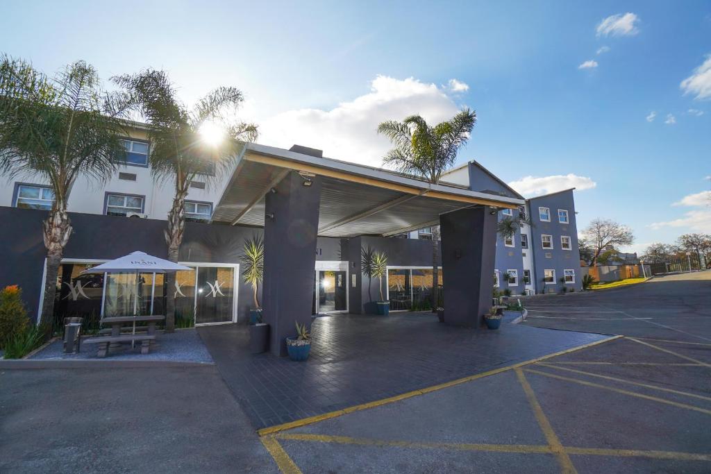 a parking lot in front of a building at Inani Hotel Gallagher in Midrand