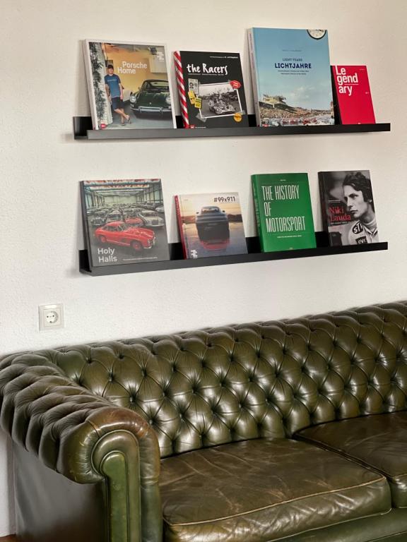 a leather couch sitting on a wall with books at The Gantry in Drees