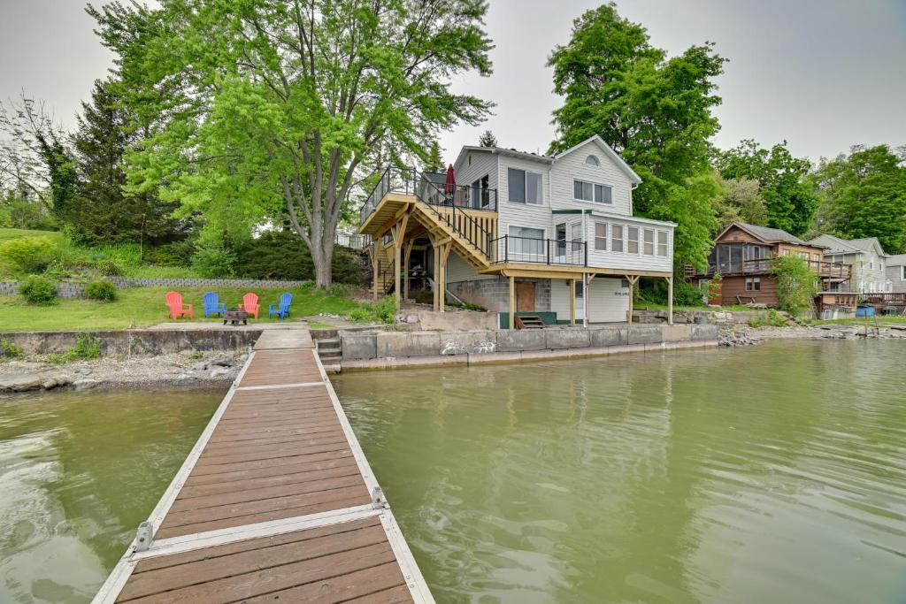 Una gran casa en el agua con un muelle de madera en Family-Friendly Cayuga Lake Retreat with Dock!, en Seneca Falls