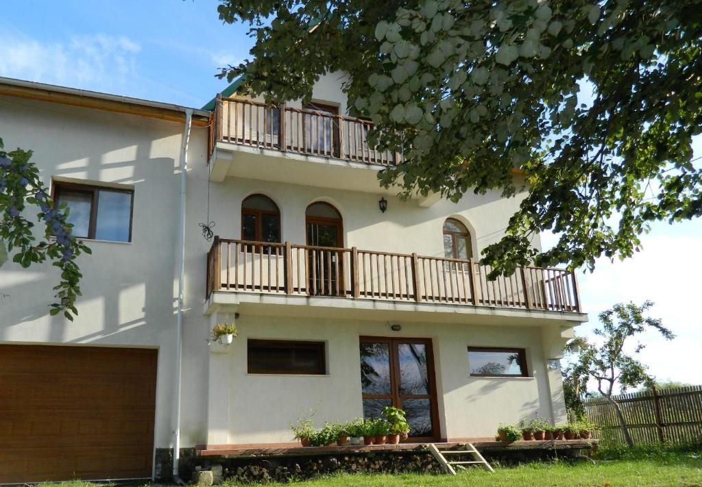 a large white house with a balcony at Belegania Villa in Oarja