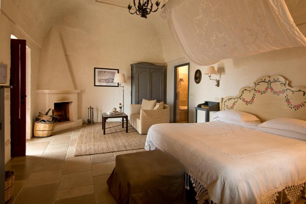A bed or beds in a room at Masseria Torre Coccaro
