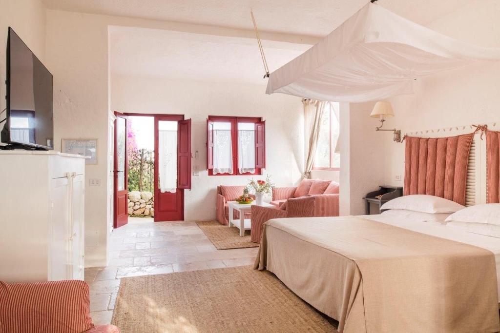 A bed or beds in a room at Masseria Torre Coccaro