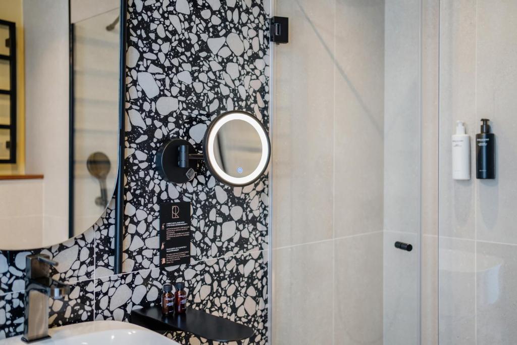a bathroom with a mirror and a sink at Hôtel Riesner in Paris
