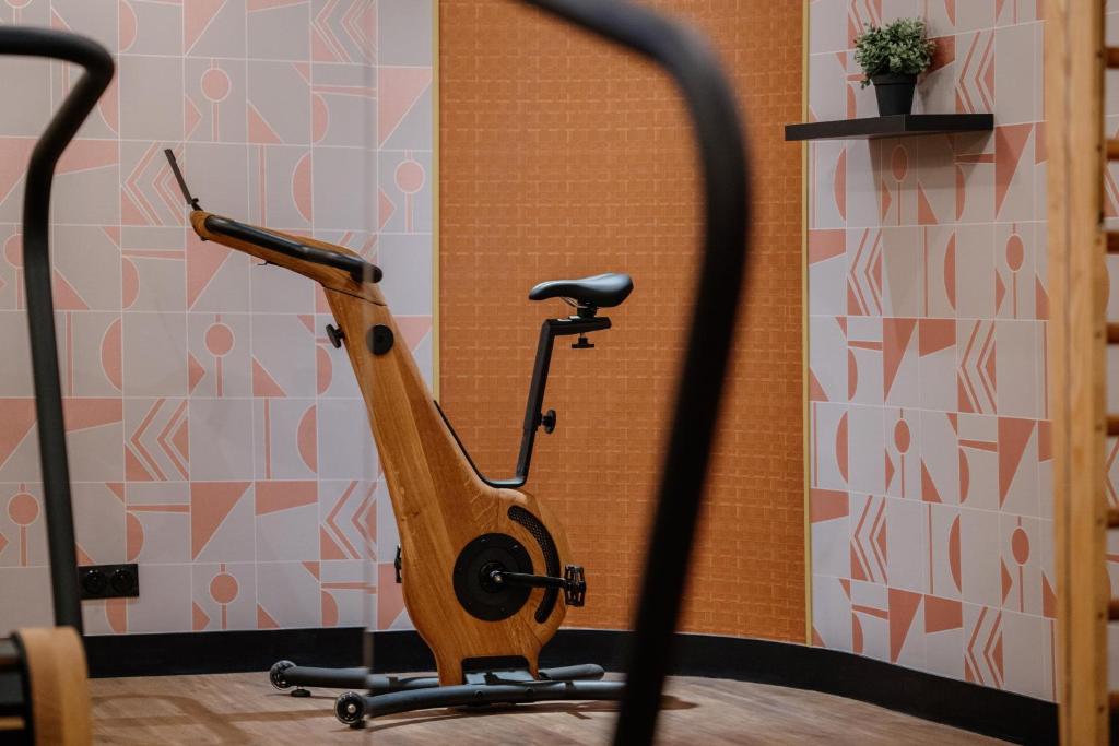 a wooden exercise bike sitting in a room at Hôtel Riesner in Paris