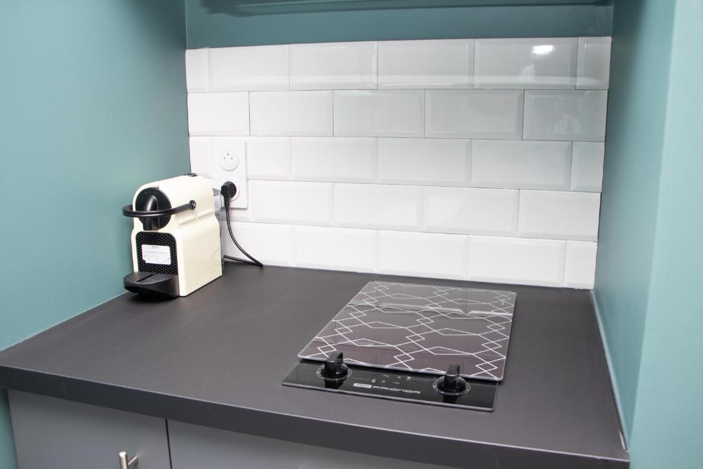 a kitchen with a counter with a book on it at Studio tout équipé centre-Ville proche de la gare in Cluses