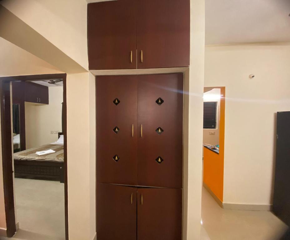 a room with a closet with a bed in it at The Pearl 1Bhk / 2Bhk in Chennai