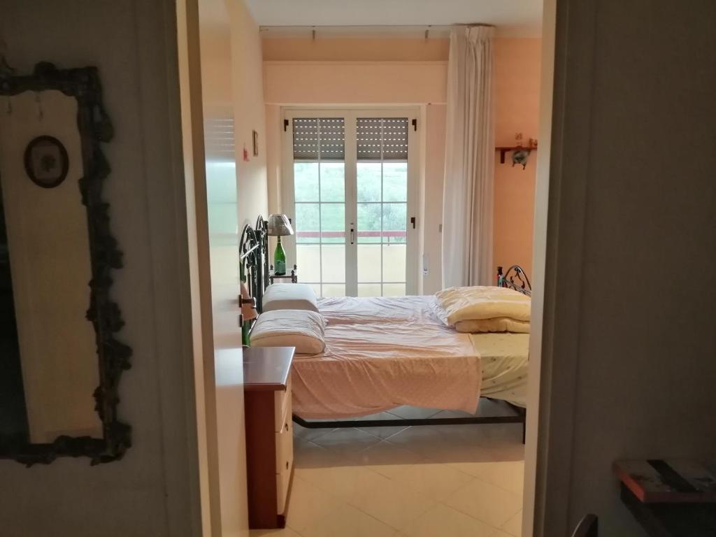 a bedroom with a bed and a window at "vista isole EGADI" Appartamento vicino mare e aeroporto in Rilievo