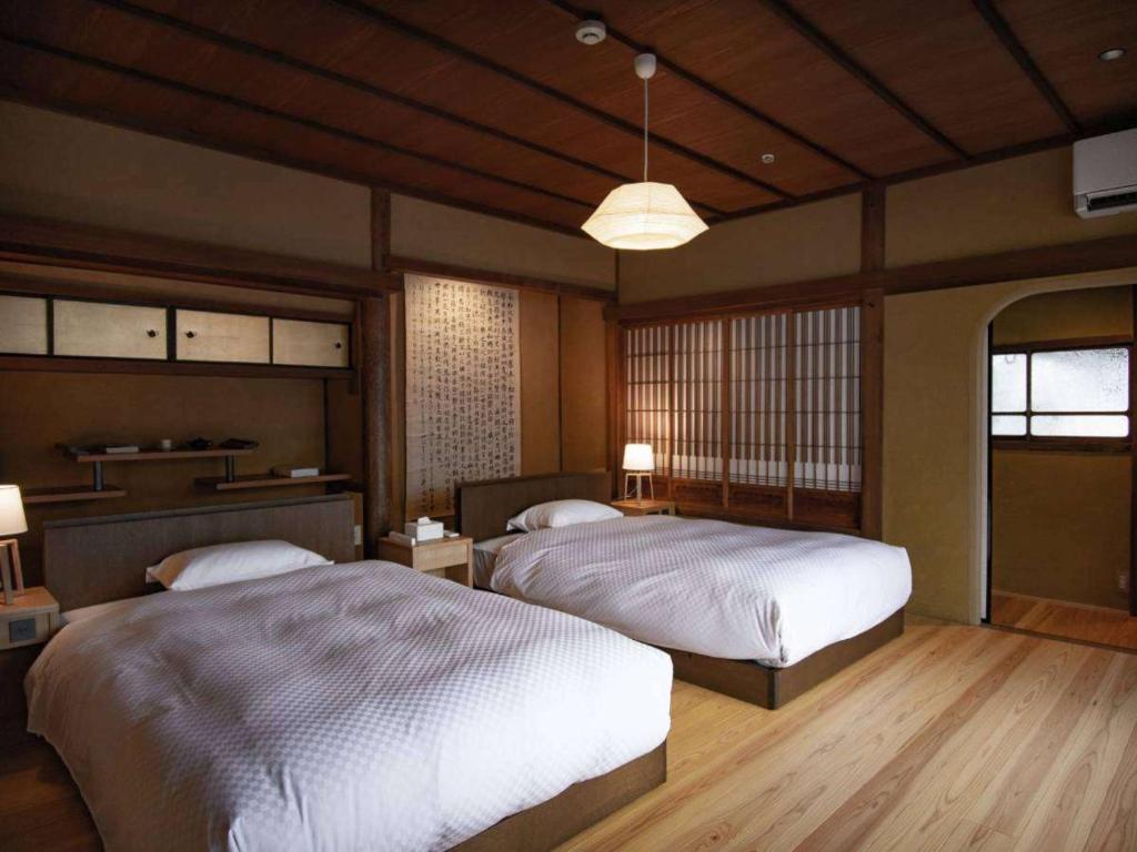 a bedroom with two beds in a room at NIPPONIA HOTEL 伊賀上野 城下町 in Iga